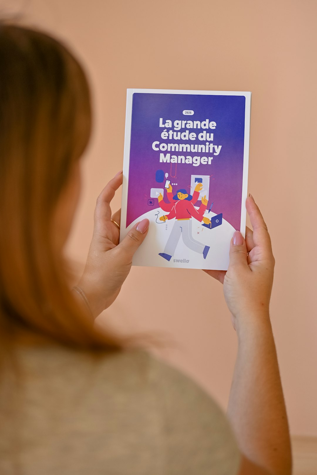 woman-holding-a-booklet-about-community-management-xlmtjvpj-ug